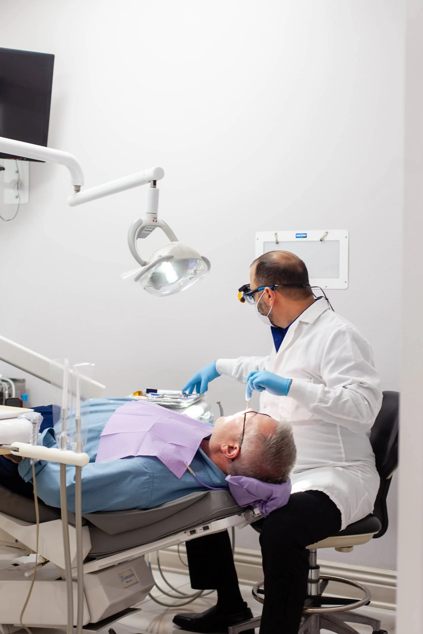 Dentist and parent reviewing a scan with a young patient
